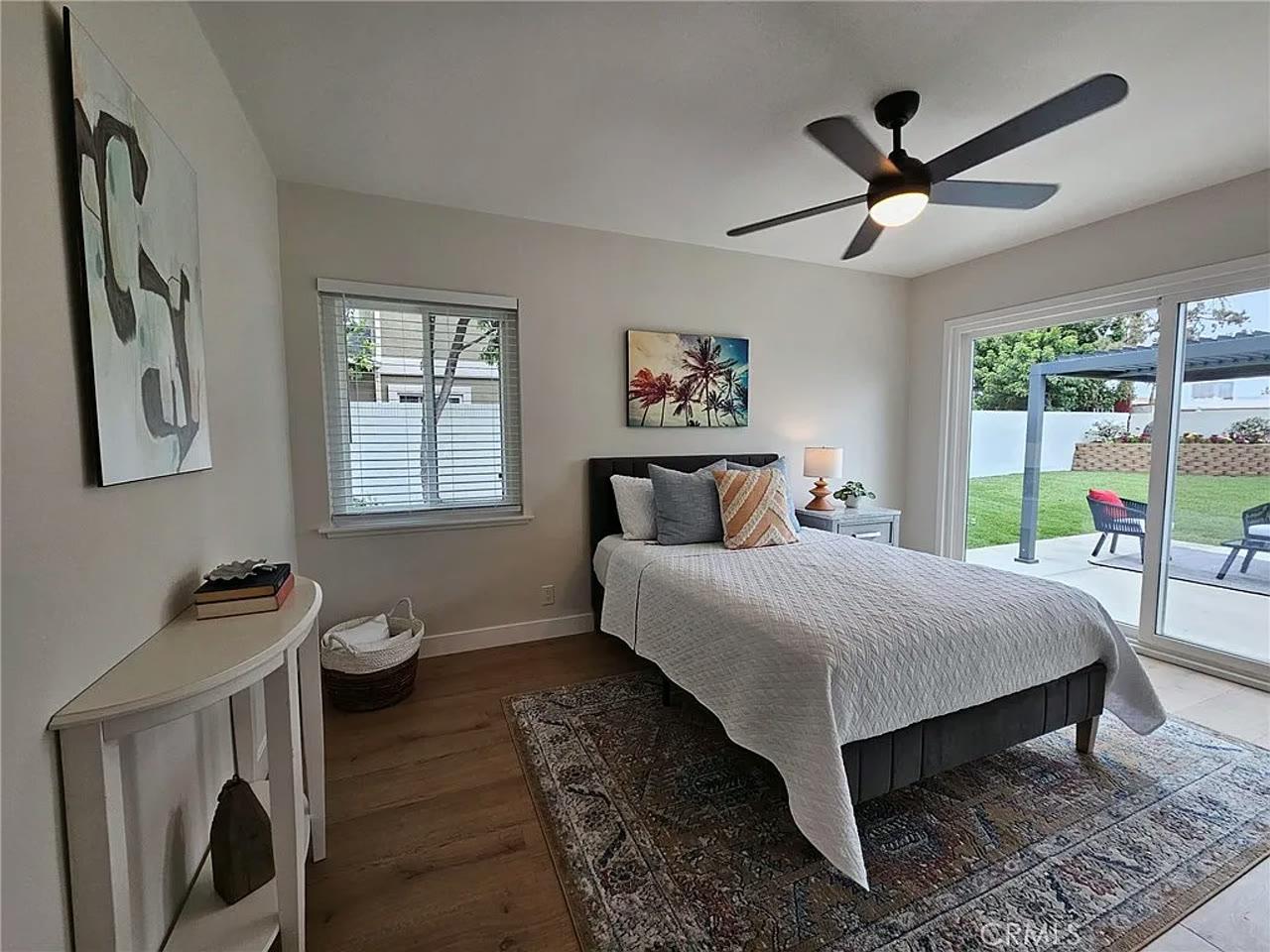 Original phone photo of the same bedroom, dim and flat